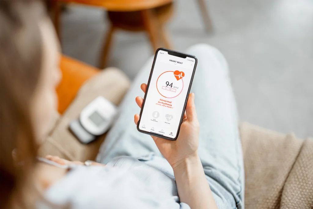 a person holding a mobile phone that shows their heartbeat at 94bpm and an abnormal arrhythmia warning