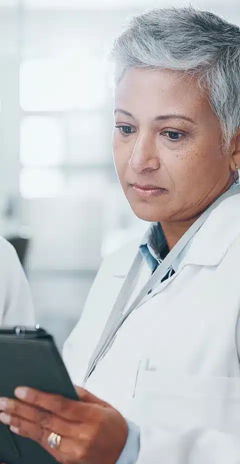 A scientist reviewing an ipad